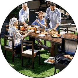 Family eating picnic in yard